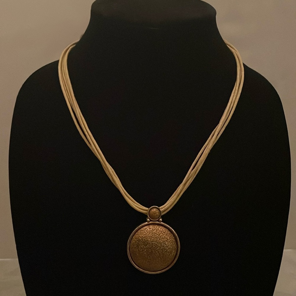 Necklace, multilayers (5 strands)  with a beautiful and unique pendant.